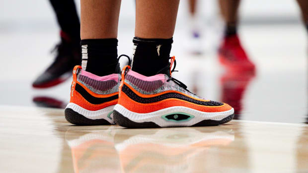 View of orange and black Nike shoes.